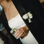 Photo of the bride wearing her husband suit jacket and holding a cocktail at dinner, at an elegant wedding planned by Yiventful Co. at MacArthur Place Hotel, Sonoma.