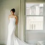 Photo of the bride in her white dress in her room, at an elegant wedding planned by Yiventful Co. at MacArthur Place Hotel, Sonoma.