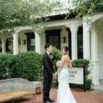 Photo of the newlywed couple posing in front of the mariage house, at an elegant wedding planned by Yiventful Co. at MacArthur Place Hotel, Sonoma.